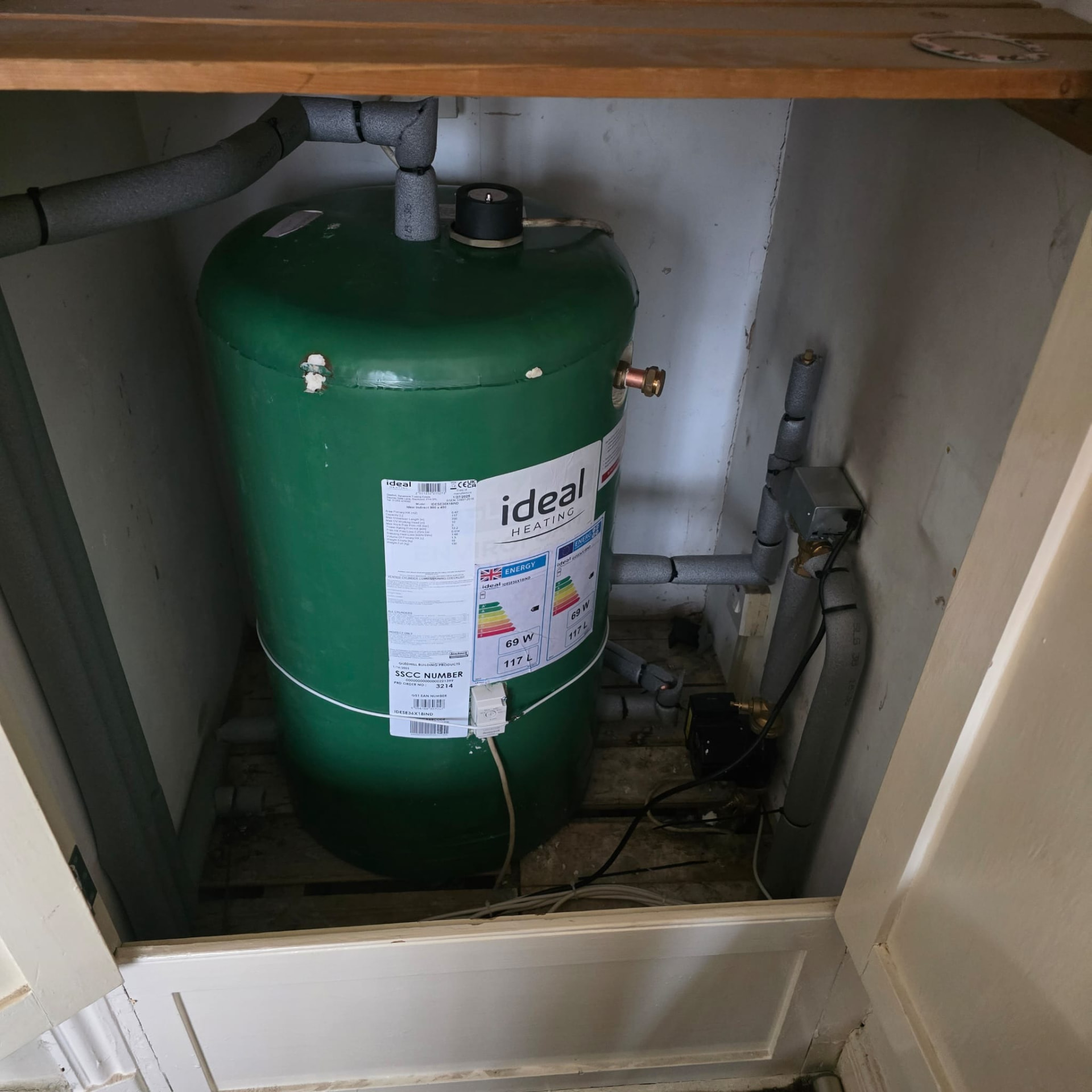 Ideal Heating hot water cylinder fitted inside a wooden cupboard after upgrade