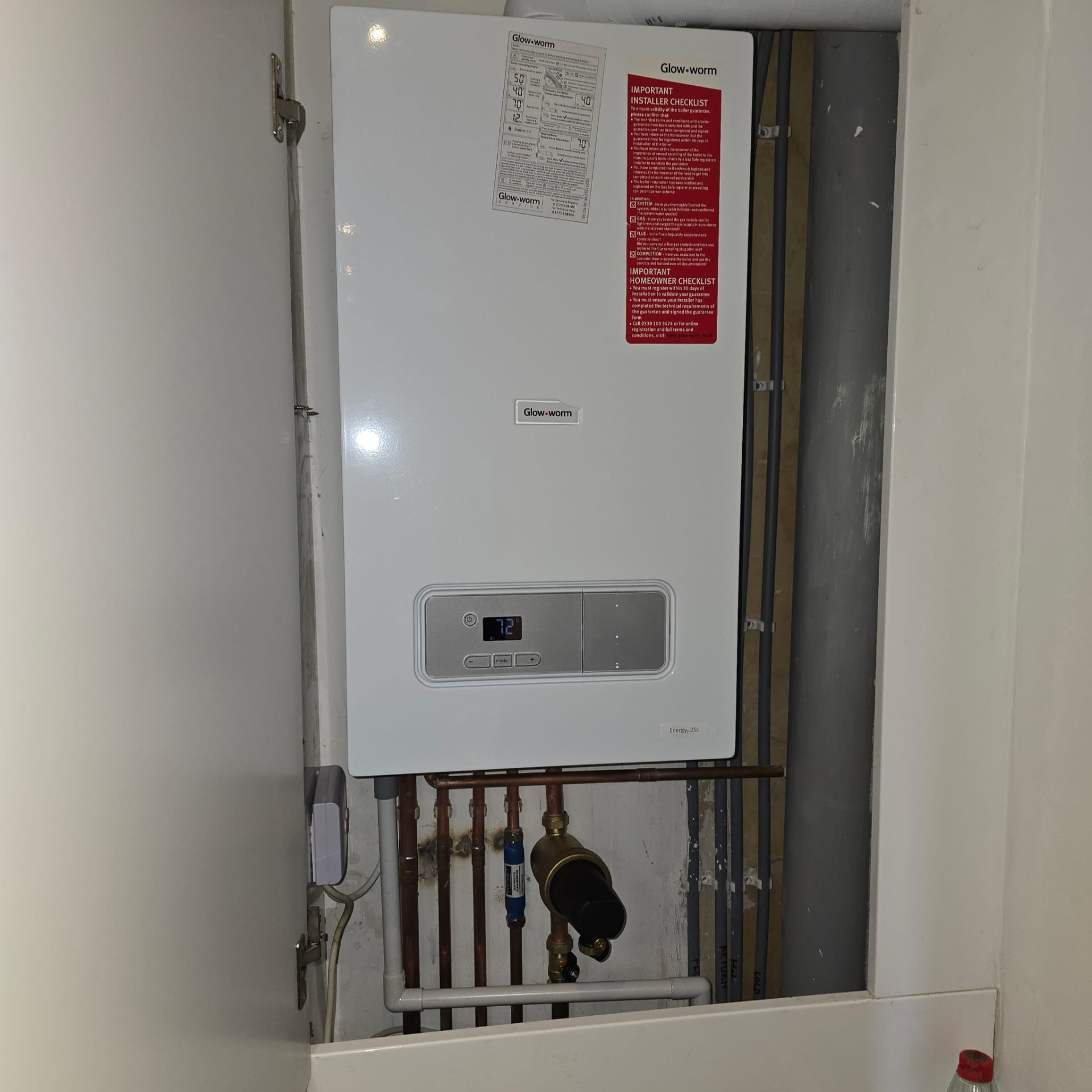 Glow-worm boiler installed in a deep white alcove cupboard